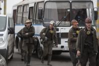 Miners arrive to help with the rescue effort in Zasyadko coal mine in Donetsk March 4, 2015. A blast at the coal mine in the eastern Ukrainian rebel stronghold of Donetsk killed more than 30 people, a local official said on Wednesday, with dozens more miners who were underground at the time unaccounted for. (REUTERS/Baz Ratner)