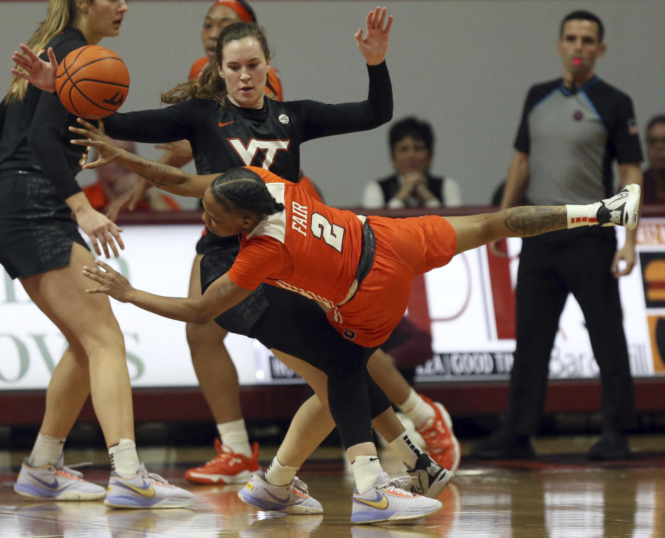 Syracuse's Dyaisha Fair (2) falls while being defended by Virginia Tech's Cayla King (22) during the first half of an NCAA college basketball game in Blacksburg, Va., Thursday, Feb. 2, 2023. (Matt Gentry/The Roanoke Times via AP)