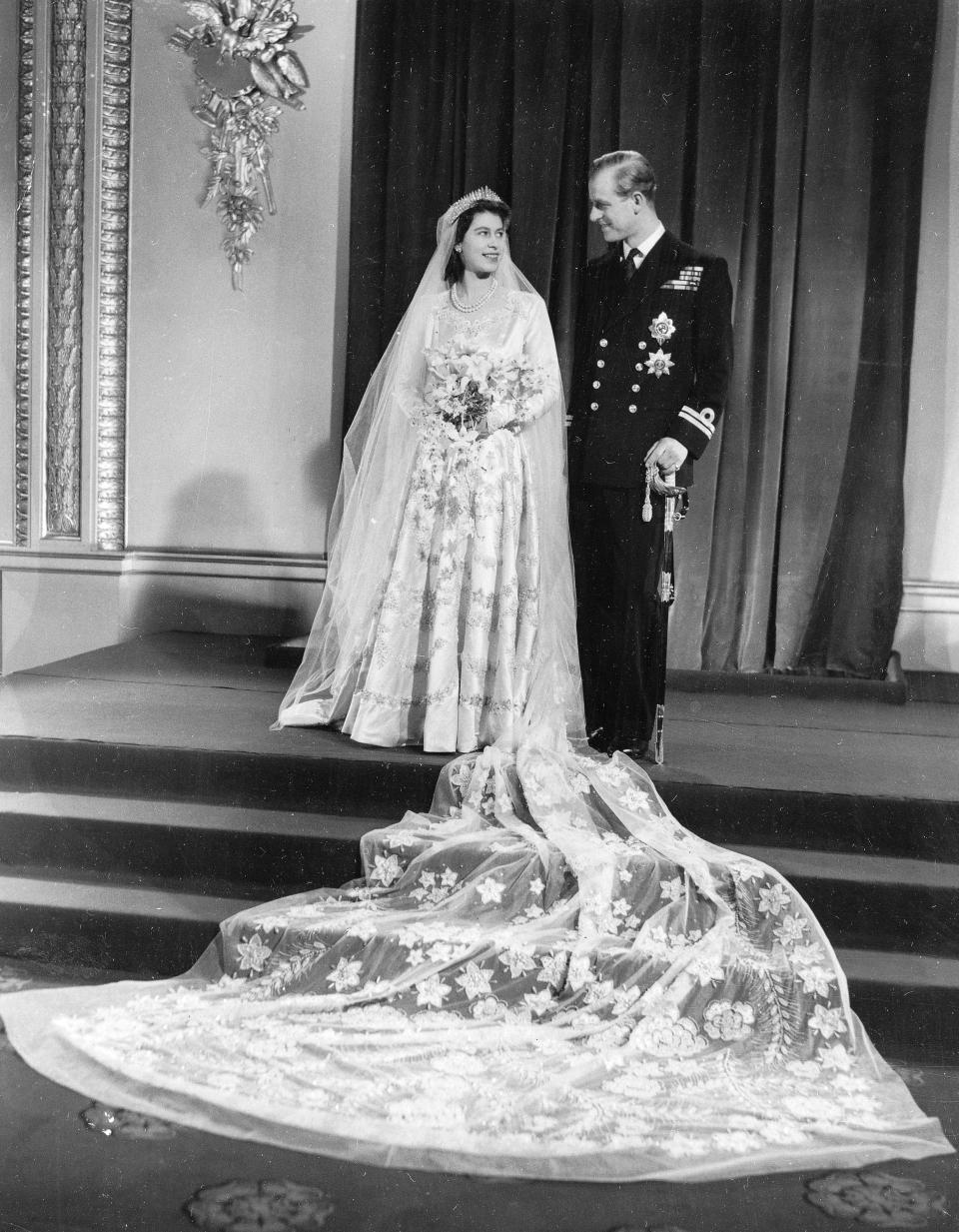 FILE - Britain's Princess Elizabeth and her new husband Prince Philip, the Duke of Edinburgh, pose for a photo at Buckingham Palace after their marriage in Westminster Abbey, in London. Nov. 20, 1947. Queen Elizabeth II will mark 70 years on the throne Sunday, Feb. 6, 2022 an unprecedented reign that has made her a symbol of stability as the United Kingdom navigated an age of uncertainty. (AP Photo, File)