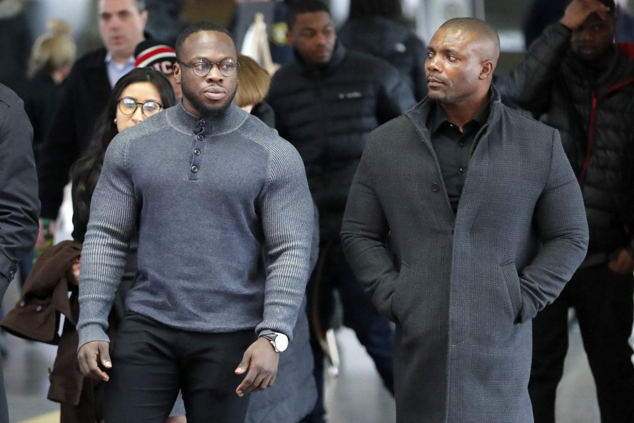 Abimbola, left, and Olabinjo Osundario, right, the two brothers who claim Jussie Smollett hired them to stage an attack on the former "Empire" actor, arrive for an initial court appearance on Monday, Feb. 24, 2020, at the Leighton Criminal Courthouse in Chicago. Smollett was indicted on a new set of charges alleging that he lied to police about being targeted in a racist and homophobic attack in downtown Chicago early last year.