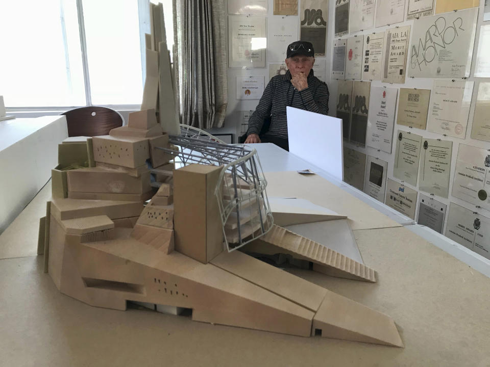 Renowned architect Antoine Predock sits in his studio in Albuquerque, N.M., April 30, 2018, behind a model of the Canadian Museum for Human Rights that he designed and was later featured on one side of the Canadian $10 bill. Predock, whose list of credits includes award-winning buildings around the world, died Saturday, March 2, 2024, at his home in Albuquerque, according to longtime friends and colleagues. He was 87. (AP Photo/Susan Montoya Bryan)