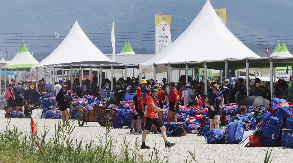 British scout members gather to leave the World Scout Jamboree campsite in Buan, South Korea, Saturday, Aug. 5, 2023. The world scouting body urged South Korea to cut short the World Scout Jamboree as thousands of British scouts began leaving the coastal campsite Saturday because of a punishing heat wave and American scouts talked of pulling out. (Kim Joo-hyung/Yonhap via AP)