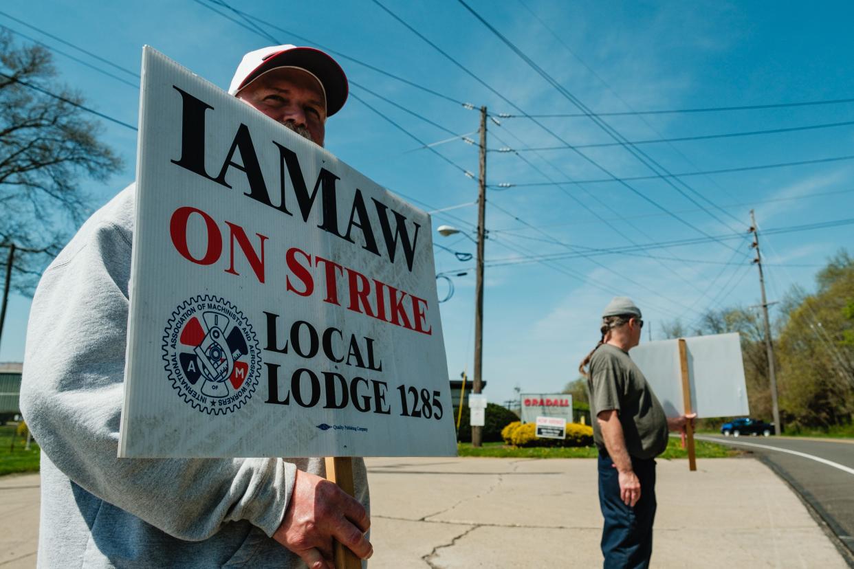 Tommy Gray, left, a Gradall Industries, Inc. assembler of 29 years, strikes along with co-worker B. Boffo, a machinist of eight years, April 15, in New Philadelphia. Both are members of the International Association of Machinists and Aerospace Workers Local 1285, which began striking at 11:59 p.m., Sunday night.