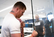 Boxer Canelo Álvarez, of Mexico, pretends to punch a wall prior to an interview with The Associated Press, Tuesday, June 28, 2022, in New York. Golovkin and Canelo Álvarez, of Mexico, will meet for a third time on Sept. 17, 2022, in Las Vegas. (AP Photo/Julia Nikhinson)