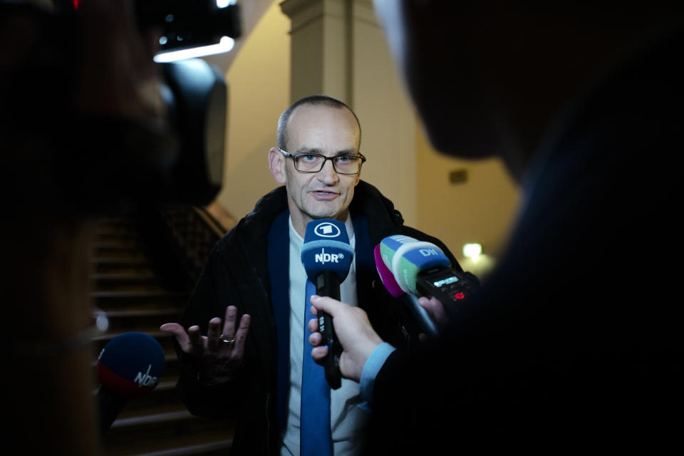 Stefan Waterkamp, lawyer of 93-year-old former SS private Bruno Dey, speaks to media at the criminal court in Hamburg, Thursday, Oct. 17, 2019. The former SS guard Bruno Dey going on trial at the court on 5,230 counts of being an accessory to murder, accused of helping the Nazis' Stutthof concentration camp function. (AP Photo/Markus Schreiber)