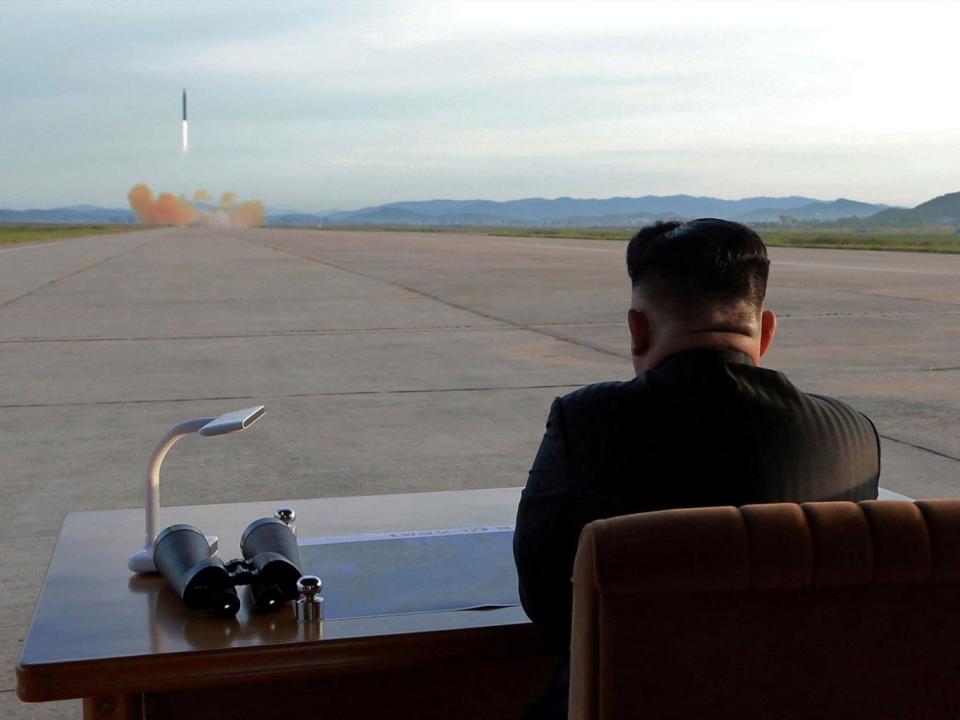 Kim Jong-un purportedly watches the launch of a Hwasong-12 missile in this undated photo released by North Korea’s news agency (Reuters)