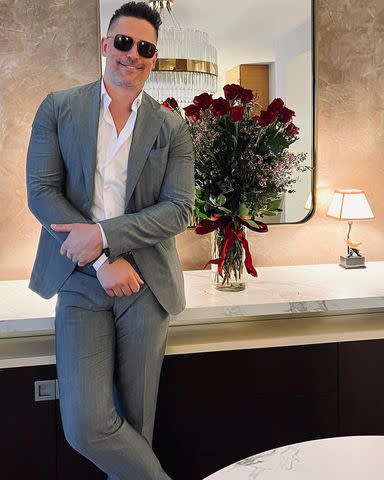 <p>Joe Manganiello/Instagram</p> Joe Manganiello poses next to a vase of red roses