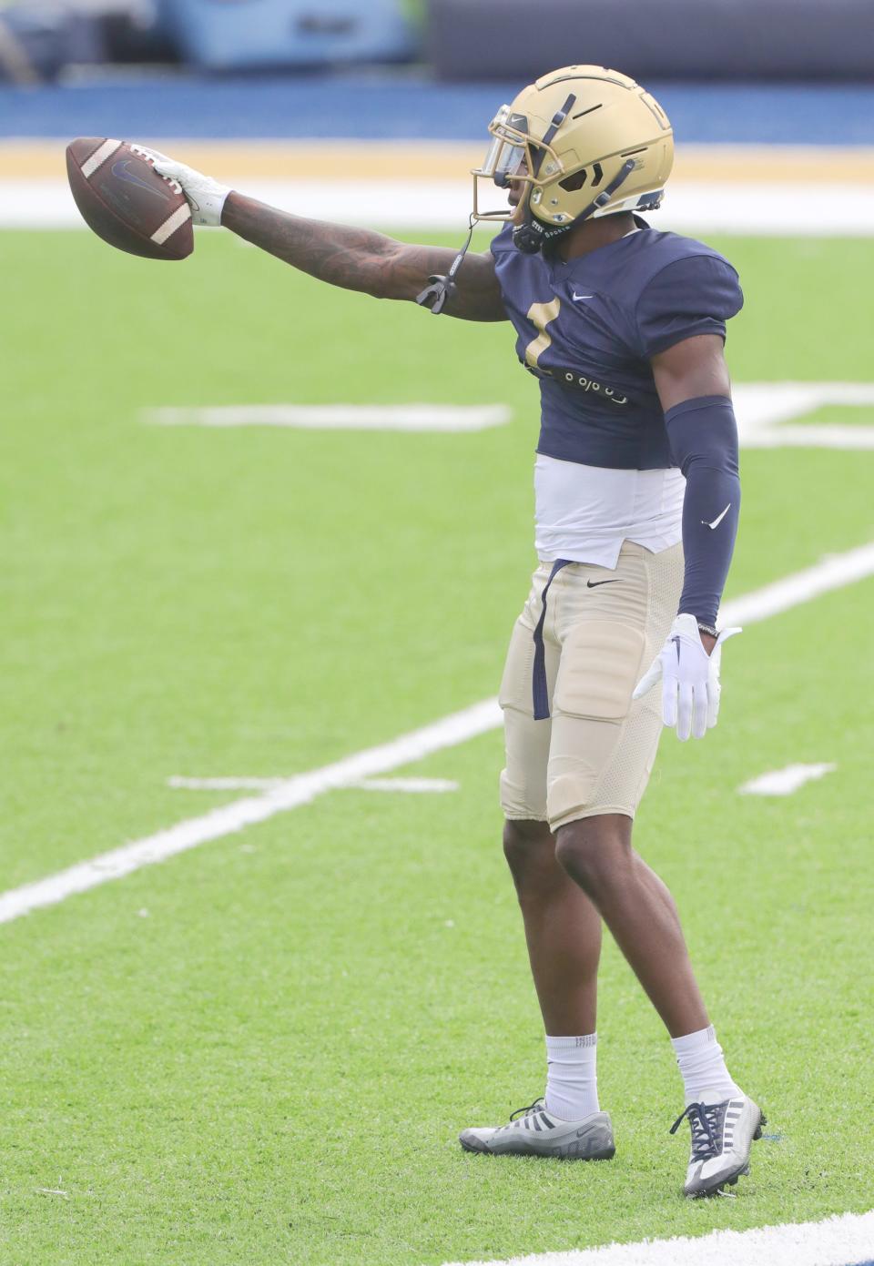 University of Akron receiver Daniel George signals first down after a catch over the middle during practice Aug. 15 in Akron.