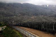 FILE PHOTO: Fences are seen on the ceasefire line between Israel and Syria in the Israeli-occupied Golan Heights