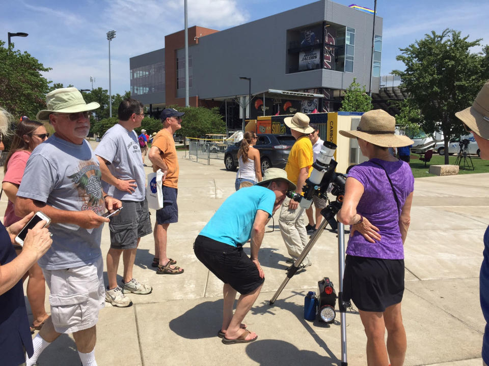 In Carbondale, Illinois, people look through a solar-viewing telescope in preparation for the total solar eclipse on Monday (Aug. 21). <cite>Denise Chow/LiveScience.com</cite>