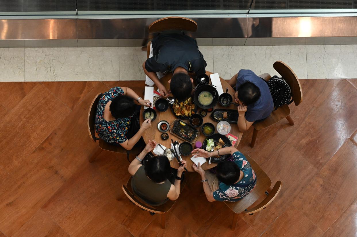 People dine at a restaurant in a shopping mall in Singapore on May 14, 2021, ahead of tightening restrictions over concerns of a rise in Covid-19 coronavirus cases. (Photo by Roslan Rahman / AFP) (Photo by ROSLAN RAHMAN/AFP via Getty Images)