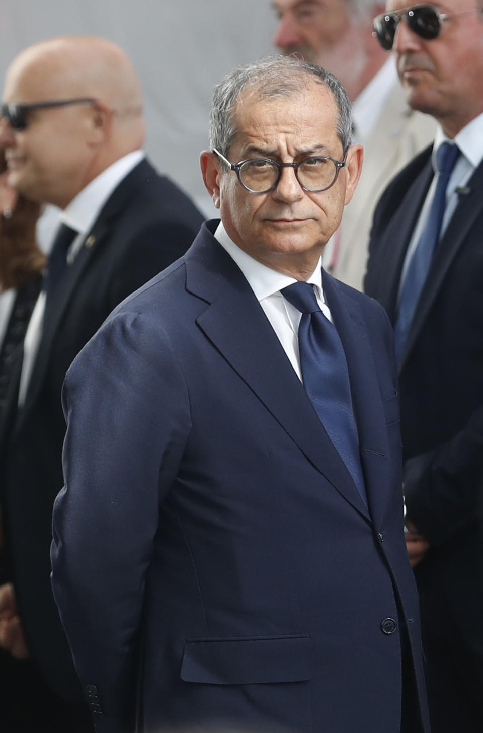 Italian Finance Minister Giovanni Tria attends a remembrance ceremony to mark the first anniversary of the Morandi bridge collapse, in Genoa, Italy, Wednesday, Aug. 14, 2019. The Morandi bridge was a road viaduct on the A10 motorway in Genoa, that collapsed one year ago killing 43 people. (AP Photo/Antonio Calanni)