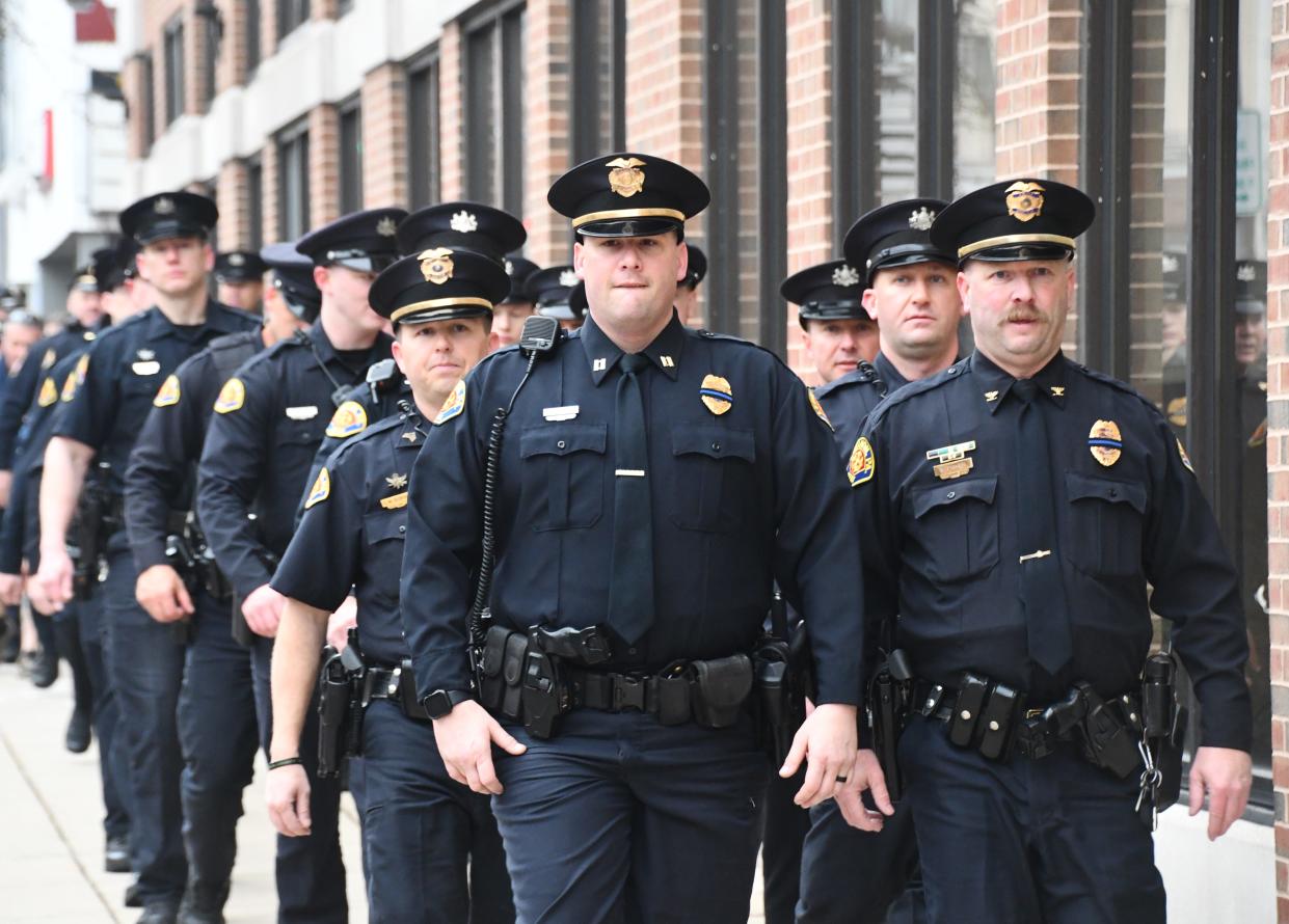 Lebanon City Police Chief Bret Fisher leads a group of officers toward city hall during a memorial walk in honor of Lt. William Lebo on March 28, 2024.