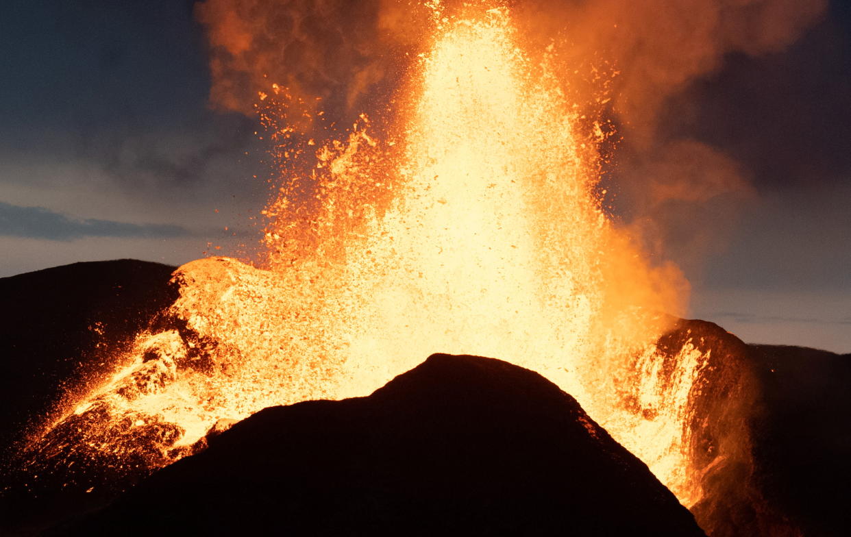 Lava erupts from a volcano.