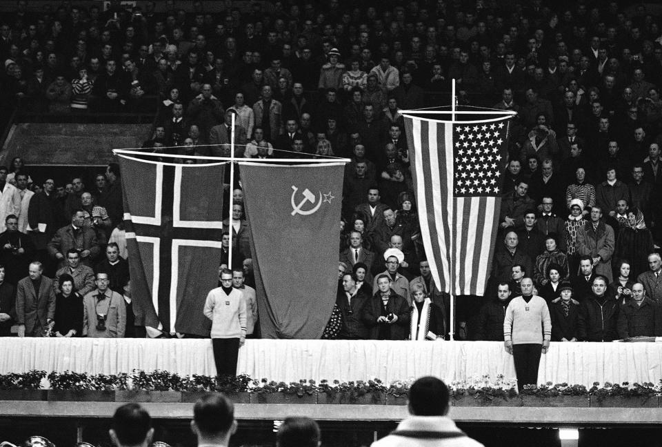 The American flag is raised during McDermott's medal ceremony at the 1964 Winter Olympics at Innsbruck, Austria.