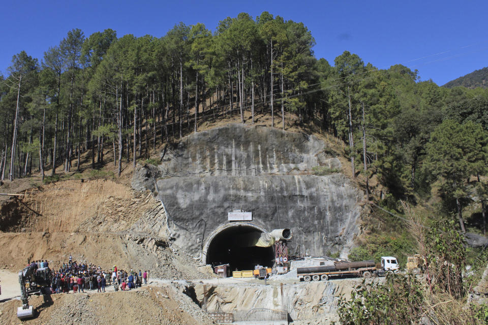 FILE- People watch rescue and relief operations at the site of an under-construction road tunnel that collapsed in mountainous Uttarakhand state, India, Wednesday, Nov. 15, 2023. Officials in India say rescuers are 5 meters (about 16.4 feet) away from the 41 construction workers who have been trapped for over two weeks, raising hopes they may be freed soon. The tunnel the workers were building is part of the Chardham all-weather road, a flagship federal project connecting various Hindu pilgrimage sites. (AP Photo/File)