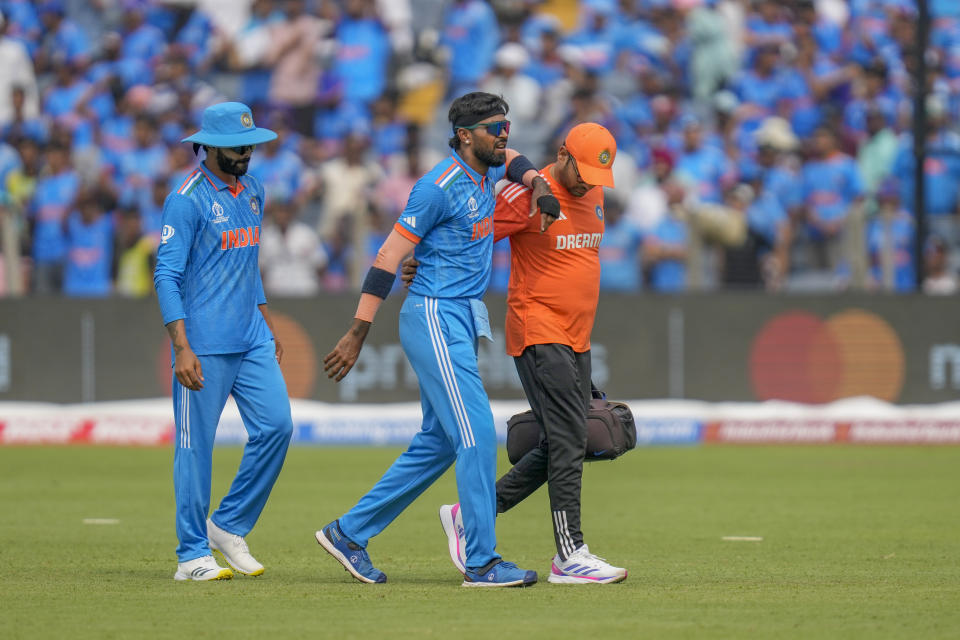 India's Hardik Pandya, center, walks off the field after sustaining an injury during the ICC Men's Cricket World Cup match between India and Bangladesh in Pune, India, Thursday, Oct. 19, 2023. (AP Photo/ Rafiq Maqbool)