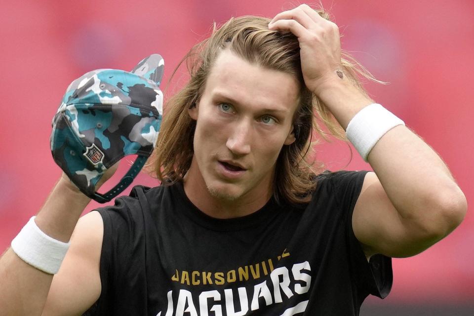 Jaguars quarterback Trevor Lawrence (16) adjusts his hair before the game between the Denver Broncos and the Jacksonville Jaguars at Wembley Stadium London on Oct. 30.