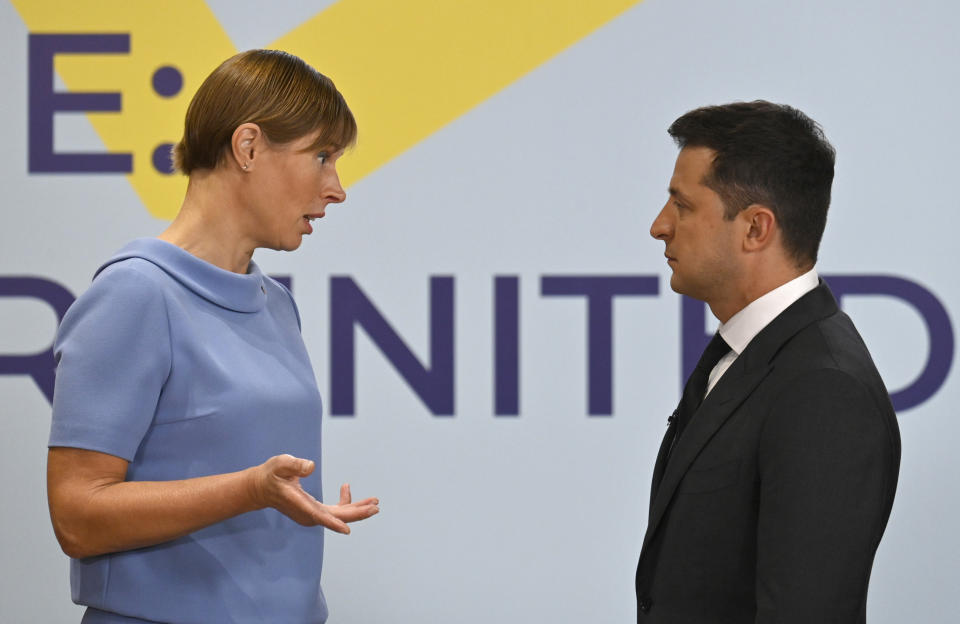 Ukrainian President Volodymyr Zelenskyy, right, and President of the Republic of Estonia, Kersti Kaljulaid talk during the Crimean Platform Summit in Kyiv, Ukraine, Monday, Aug. 23, 2021. The Crimea Platform is a new international consultation and coordination format to strengthen an international response to the ongoing Russia's occupation of Crimea. (Ukrainian Presidential Press Office via AP)