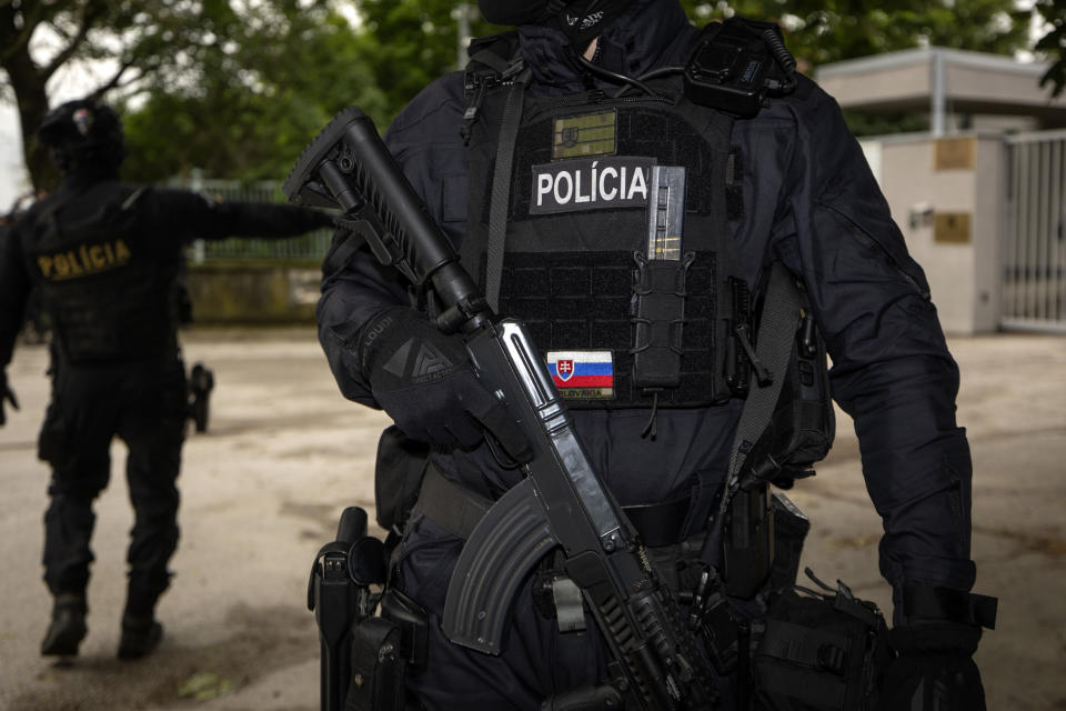 Policemen guard the area as they wait for the suspect, in shooting of Slovakia's Prime Minister Robert Fico, to be brought to court in Pezinok, Slovakia, Saturday, May 18, 2024. Officials in Slovakia say Prime Minister Robert Fico has undergone another operation two days after his assassination attempt and remains in serious condition. (AP Photo/Tomas Benedikovic)