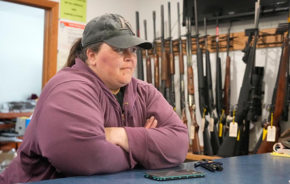 Jennifer Lovelace, the wife of Chuck Lovelace, owner of Essential Shooting Supplies, works behind the counter at their gun shop in Park Falls.