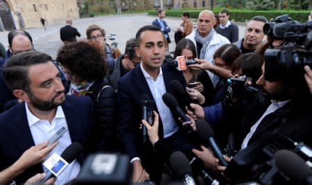 FILE PHOTO: 5-Star Movement Luigi Di Maio (C) and Giancarlo Cancelleri speak with media prior to a rally for a regional election in Palermo, Italy, November 3, 2017. REUTERS/Guglielmo Mangiapane/File Photo