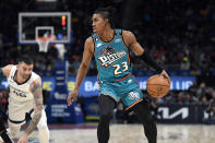 Detroit Pistons guard Jaden Ivey, right, dribbles as Memphis Grizzlies guard John Konchar tries to reach him during the second half of an NBA basketball game, Sunday, Dec. 4, 2022, in Detroit. (AP Photo/Jose Juarez)