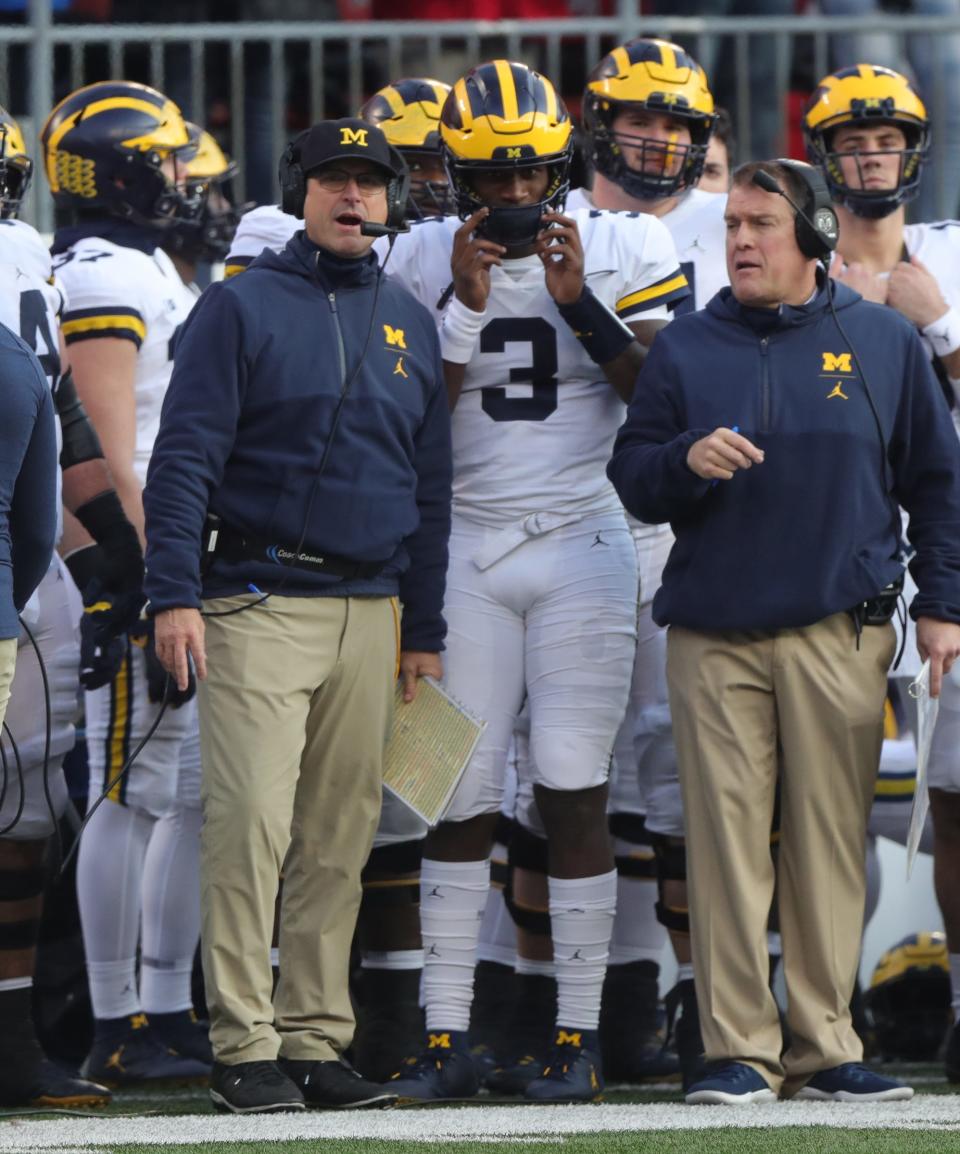 Michigan head coach Jim Harbaugh talks with quarterback Joe Milton and offensive line coach Ed Warinner during the second half against Ohio State, Saturday, Nov. 24, 2018 at Ohio Stadium in Columbus, Ohio.