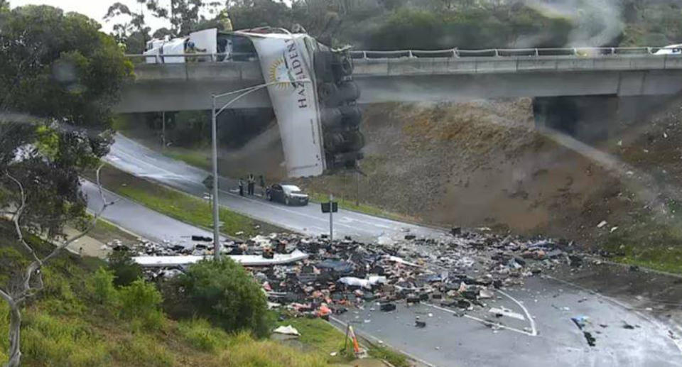 A truck crashed off a bridge at the Calder Freeway at Keilor shortly after 5pm on Tuesday spilling debris across the freeway below. Source: Facebook/ Vic Traffic