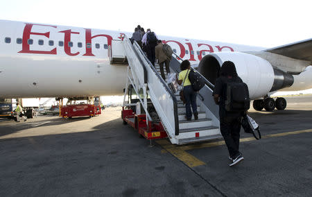 Passengers board an Ethiopian Airlines plane at Jomo Kenyatta airport in Kenya's capital of Nairobi January 25, 2010. REUTERS/Thomas Mukoya/Files