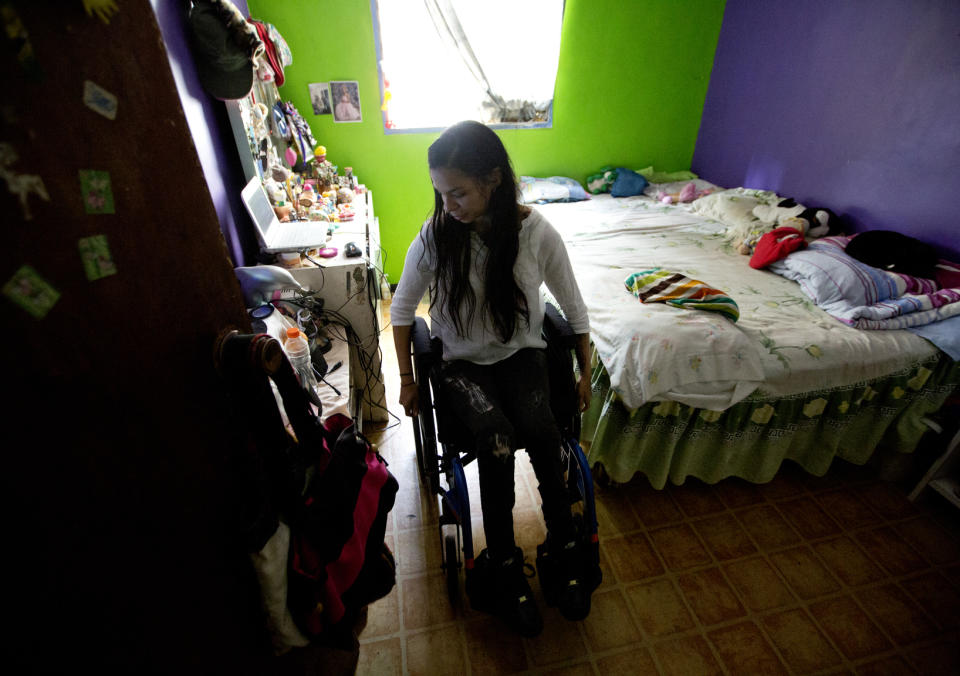 This Dec. 17, 2018 photo shows dancer Iraly Yanez in her home in Caracas, Venezuela. The ballerina was hit by a stray bullet on New Year's eve in 2010 as she entered her home in a crime-ridden slum. That was the end of her dancing until she joined AM Danza in September. (AP Photo/Fernando Llano)