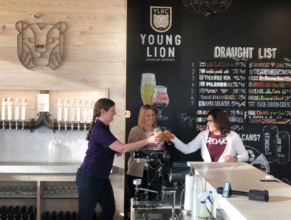 Meaghan de Chateauvieux (left), president and CEO of Willow Domestic Violence Center; Kim Porter, special projects manager with the New York State Brewers Association; and Jennifer Newman, co-owner of Young Lion Brewing Co.; toast the release of Raise Up, a beer brewed by local women in the craft beer industry.