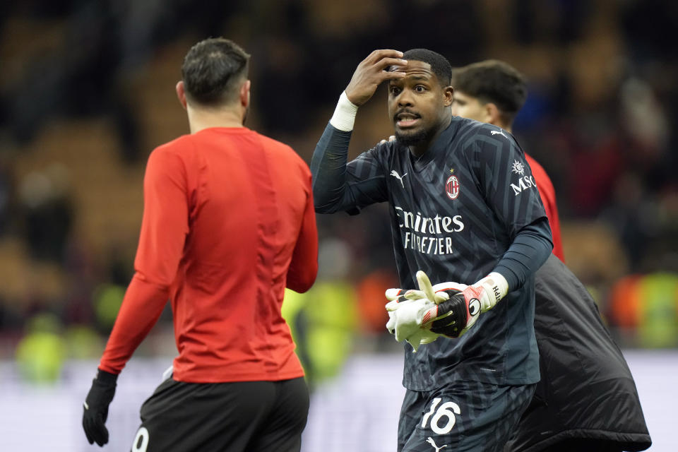 AC Milan's goalkeeper Mike Maignan and Theo Hernandez, left, speak with each other at the end of the Serie A soccer match between AC Milan and Frosinone at the San Siro stadium, in Milan, Italy, Saturday, Dec. 2, 2023. Milan won 3-1. (AP Photo/Luca Bruno)