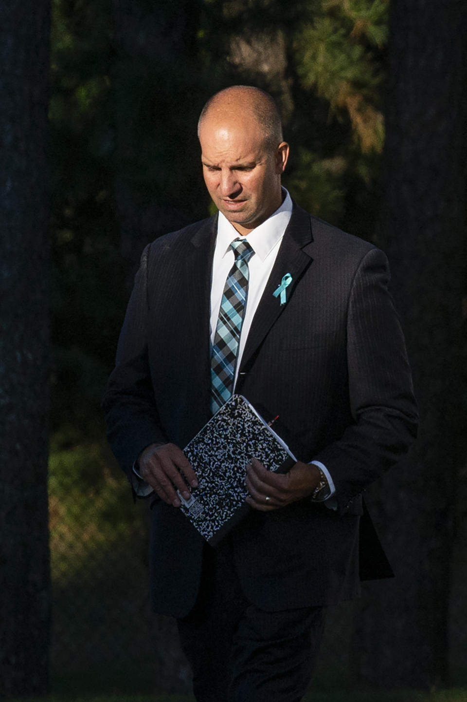 Gabby Petito's stepdad Jim Schmidt, right, walks the end of the funeral home viewing of Gabby Petito at Moloney's Funeral Home in Holbrook, N.Y. Sunday, Sept. 26, 2021. (AP Photo/Eduardo Munoz Alvarez)