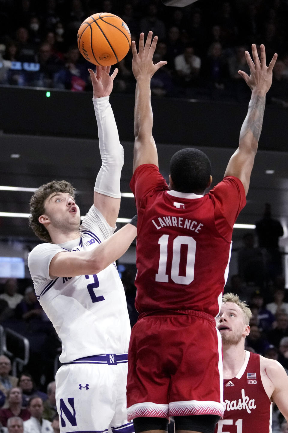 Northwestern forward Nick Martinelli, left, shoots over Nebraska guard Jamarques Lawrence during the second half of an NCAA college basketball game in Evanston, Ill., Wednesday, Feb. 7, 2024. Northwestern won 80-68. (AP Photo/Nam Y. Huh)