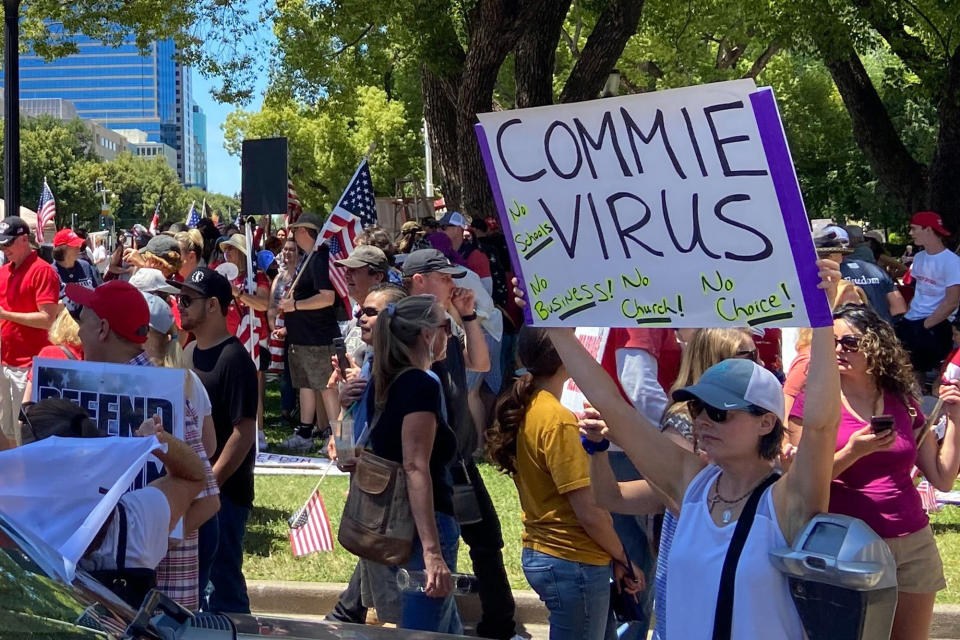 Protesters gathered outside the "Liberty Fest" rally in front of California State Capitol, Saturday, May 23, 2020, in Sacramento, Calif., to protest Gov. Gavin Newsom's Stay At Home Order to stem the coronavirus outbreak. (AP Photo/Cuneyt Dil)