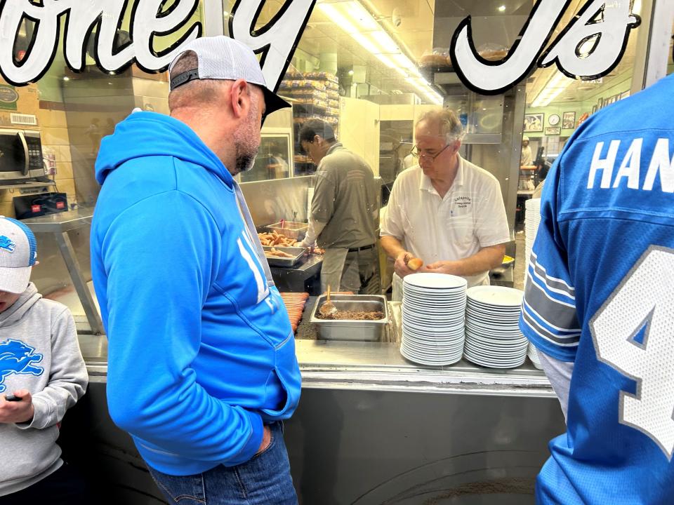 Hungry customers wait to get inside Lafayette Coney Island during the second day of the NFL draft Friday.
