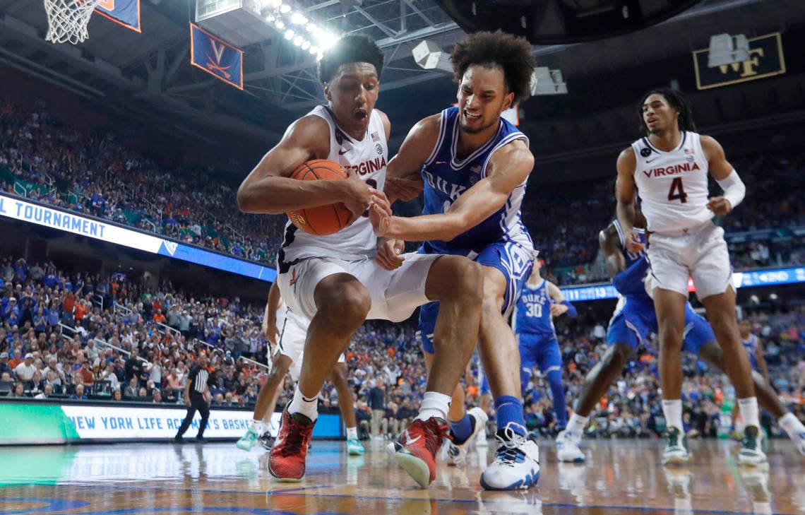 Duke’s Dereck Lively II (1) attempts to steal the ball from Virginia’s Ryan Dunn (13) during Duke’s 59-49 victory over Virginia to win the ACC Men’s Basketball Tournament in Greensboro, N.C., Saturday, March 11, 2023.