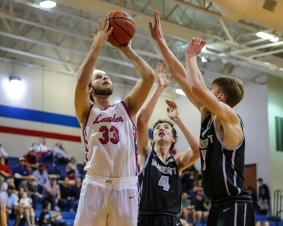 Sean Dalberg powers to the basket for Leander against the Vandegrift defense during a frenetic nondistrict game Tuesday at Leander High School. Dalberg led the Lions with 12 points in a 48-34 victory.