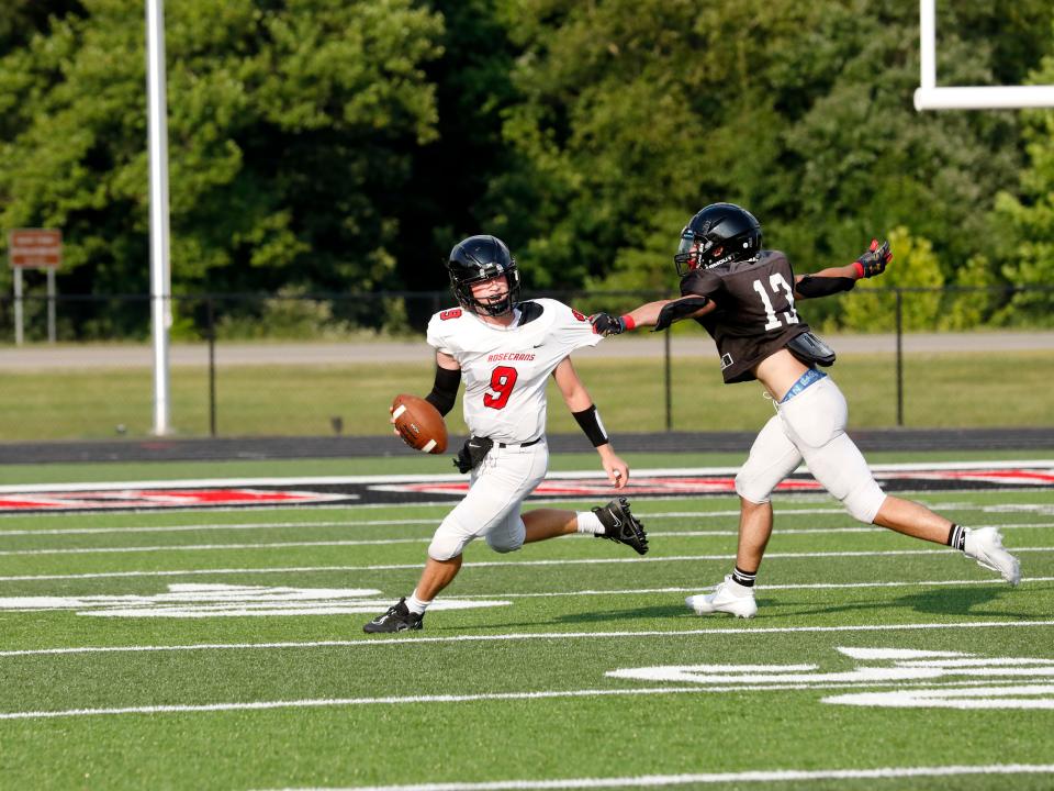 Rosecrans quarterback Brendan Bernath tries to elude Crooksville's Seth Dalrymple during a high school football scrimmage on Friday, Aug. 4, 2023, in McLuney, Ohio.