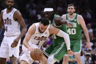 Cleveland Cavaliers guard Max Strus (1) drives against Boston Celtics guard Jrue Holiday, center right, during the second half of Game 4 of an NBA basketball second-round playoff series, Monday, May 13, 2024, in Cleveland. (AP Photo/David Dermer)