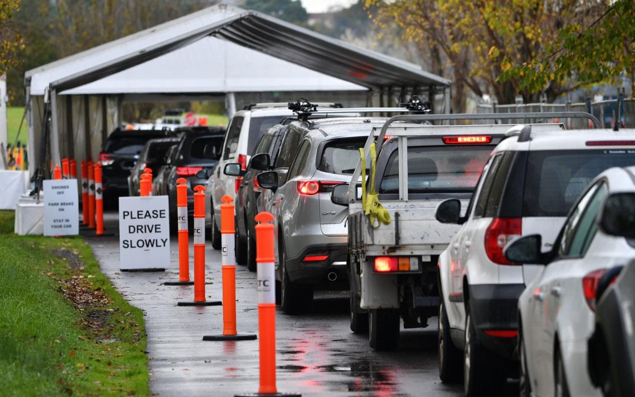 Cars are seen lined up at the Albert Park Covid-19 testing facility in Melbourne - JAMES ROSS/EPA-EFE/Shutterstock