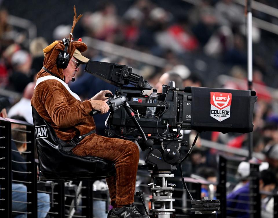 A cameraman works the game dressed as a reindeer as Utah and Northwestern play in the SRS Distribution Las Vegas Bowl at Allegiant Stadium on Saturday, Dec. 23, 2023. Northwestern won 14-7. | Scott G Winterton, Deseret News