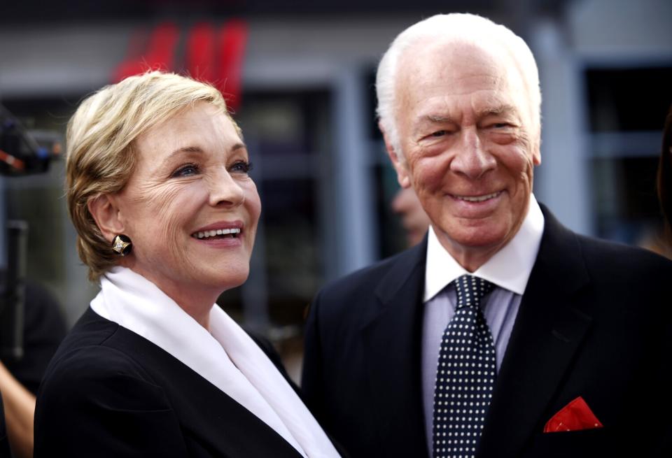 An older woman, left, and an older man in formalwear