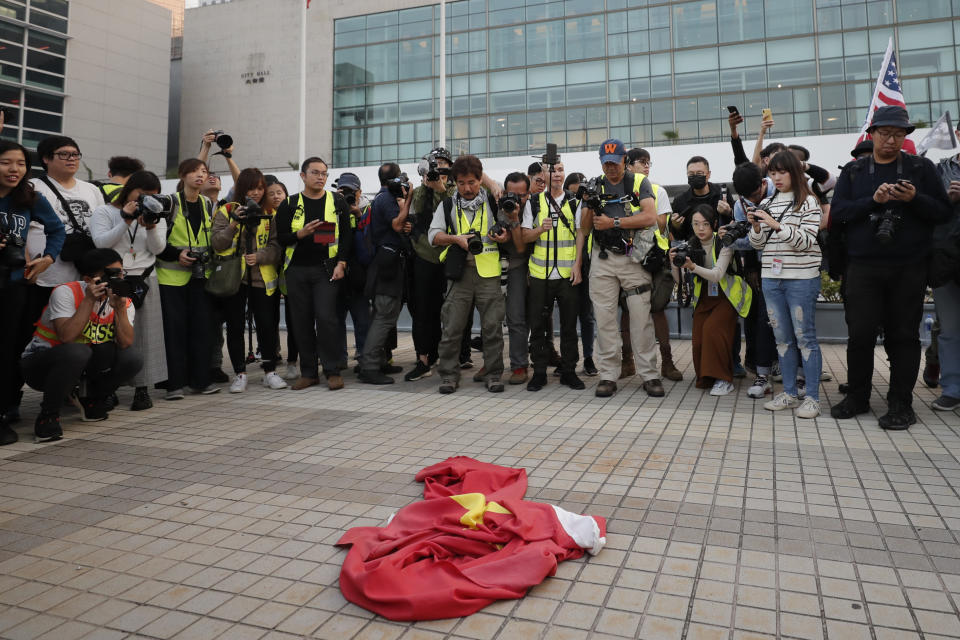 A Chinese flag lies on the ground during a rally to show support for Uighurs and their fight for human rights in Hong Kong, Sunday, Dec. 22, 2019. (AP Photo/Lee Jin-man)