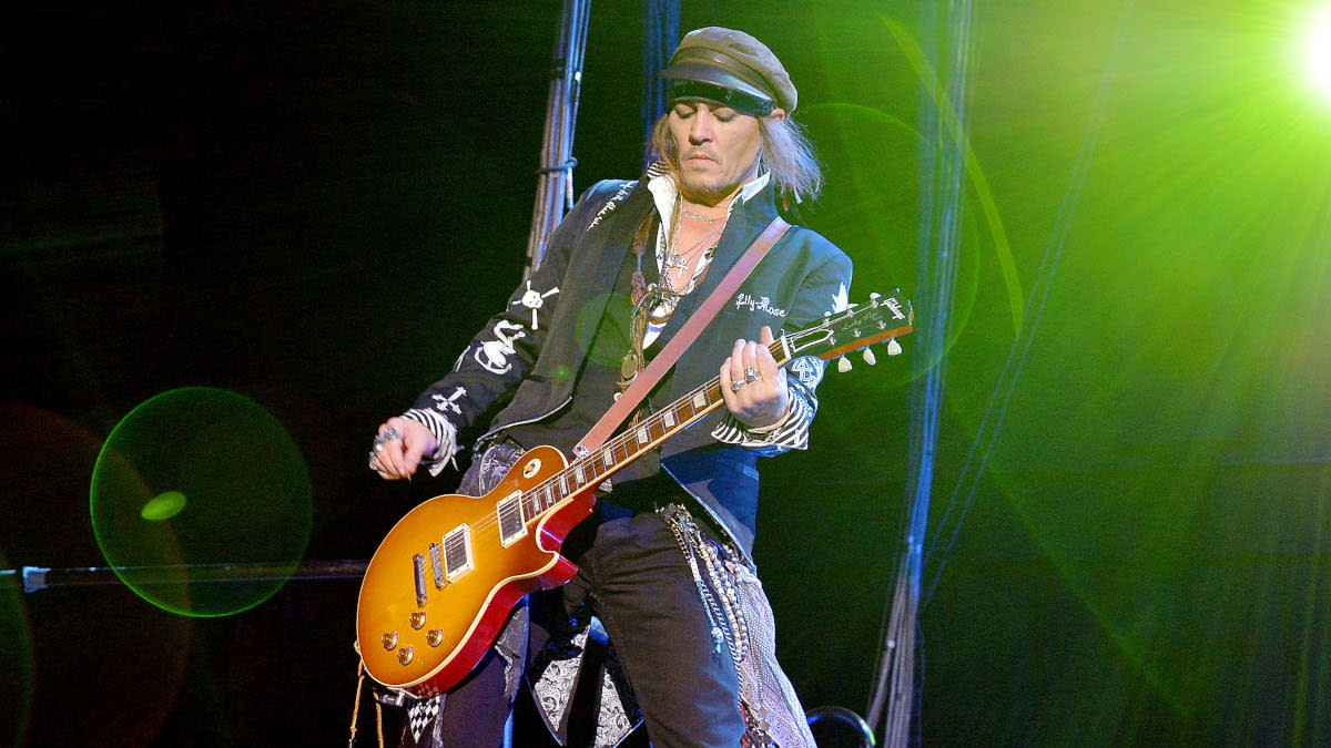  Johnny Depp playing guitar on stage. 