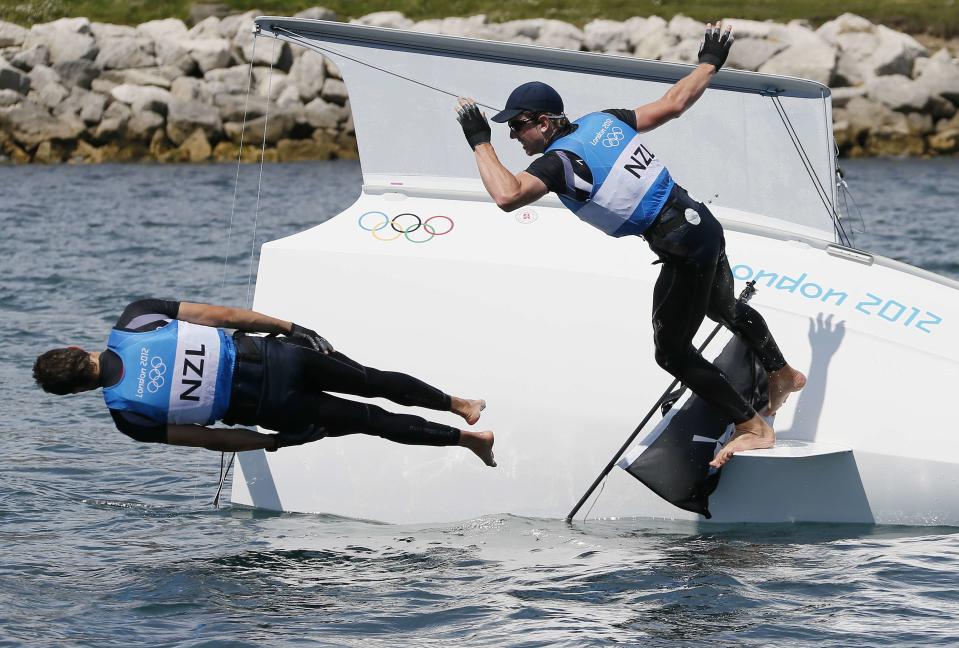 New Zealand's Peter Burling (R) and Blair Tuke celebrate winning silver in the 49er sailing class at the London 2012 Olympic Games in Weymouth and Portland, southern England, August 8, 2012. REUTERS/Pascal Lauener (BRITAIN - Tags: SPORT YACHTING OLYMPICS TPX IMAGES OF THE DAY) 