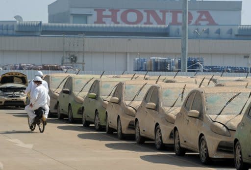 Flood damaged cars are seen at a Honda factory in Thailand's Ayutthaya province, in December 2011. Japan's economy was hit by severe flooding in Thailand in late 2011, disrupting global supply chains and the production capability of Japanese manufacturers, particularly in electronics and automobiles