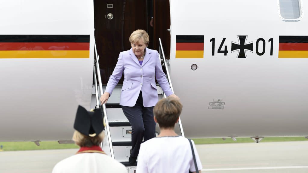 German Chancellor Angela Merkel disembarks a plane.