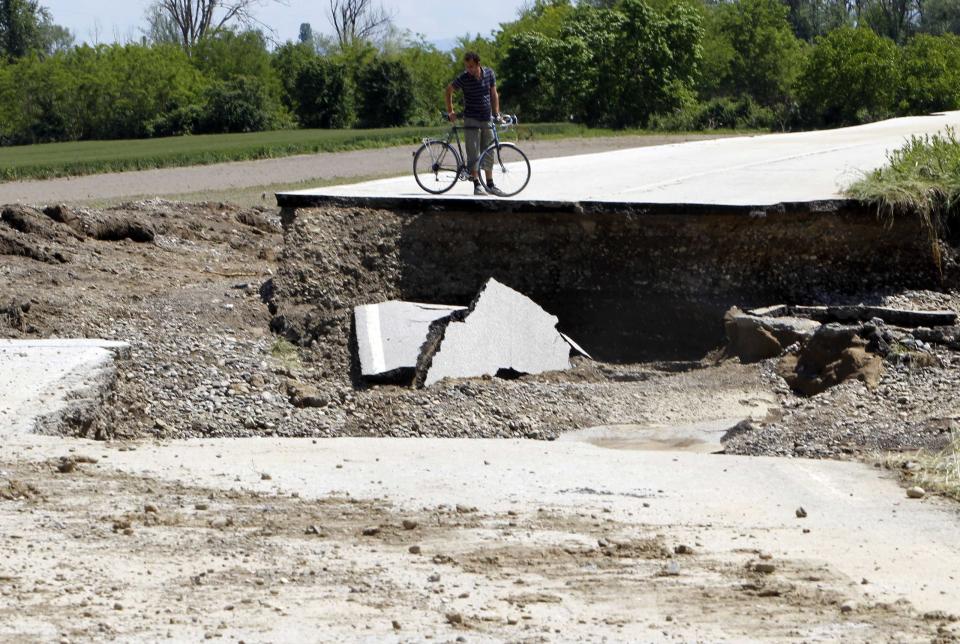 A man observe damaged road after heavy floods in Odzak